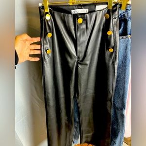 Ankle length black pleather pants, gold button detail